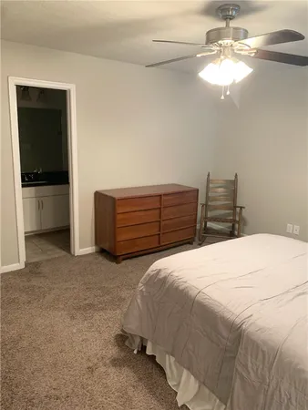 a bedroom with bed and a chandelier