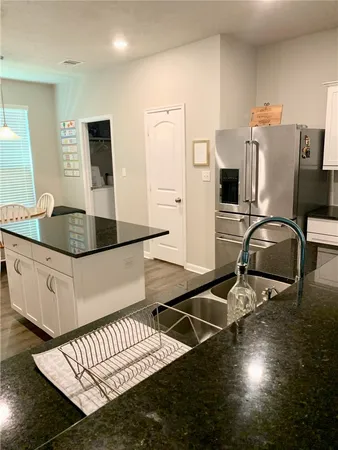 a kitchen with sink and refrigerator