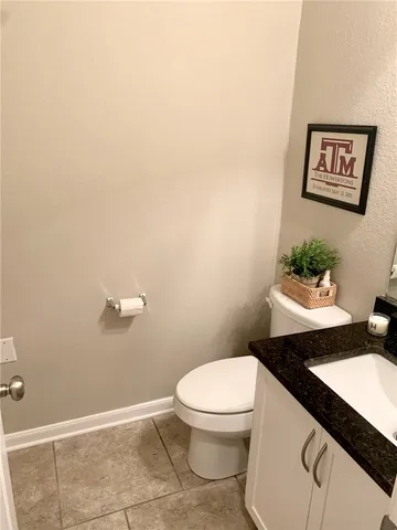 a white toilet sitting next to a bathroom sink