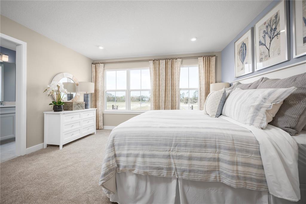 562 Creedmore Lane DeBary, FL 32713 - Photo 11 of 17 a spacious bedroom with a large bed and a window