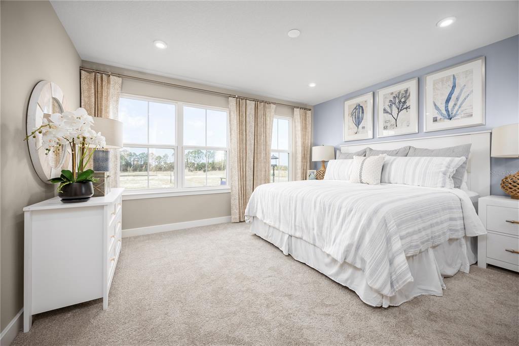 562 Creedmore Lane DeBary, FL 32713 - Photo 12 of 17 a spacious bedroom with a large bed and a window