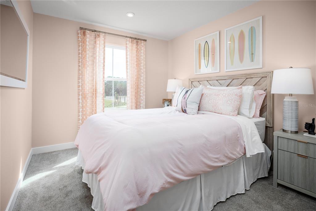 562 Creedmore Lane DeBary, FL 32713 - Photo 14 of 17 a bedroom with a bed and a lamp