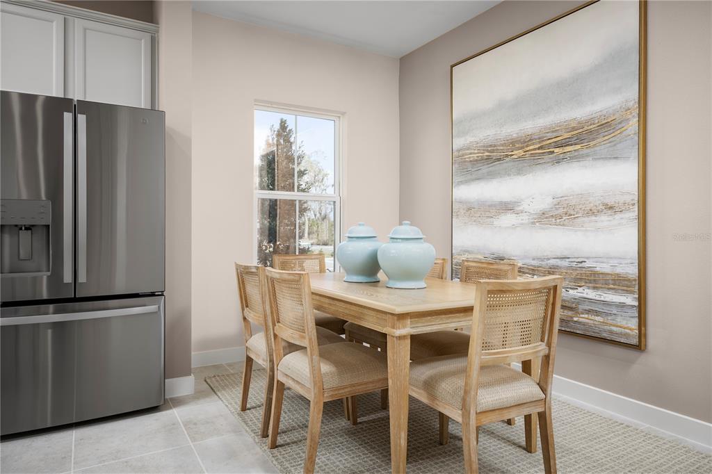 562 Creedmore Lane DeBary, FL 32713 - Photo 8 of 17 a dining room with furniture large window and refrigerator