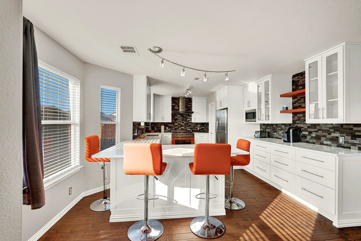 113 Endeavour Kyle, TX 78640 - Photo 11 of 38 Kitchen featuring white cabinets, glass fronted cabinets, a breakfast bar, stainless steel appliances