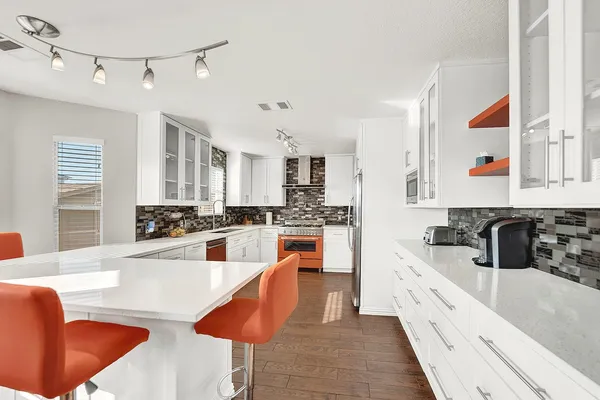 a kitchen with stainless steel appliances granite countertop a sink and cabinets