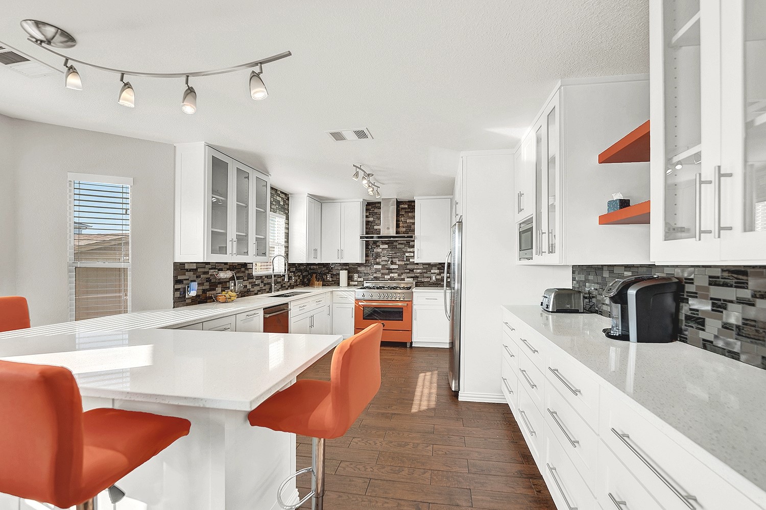 113 Endeavour Kyle, TX 78640 - Photo 12 of 38 Kitchen featuring glass insert cabinets, stainless steel appliances, updated backsplash and track lighting