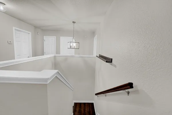 a bedroom with a bed chandelier and a window
