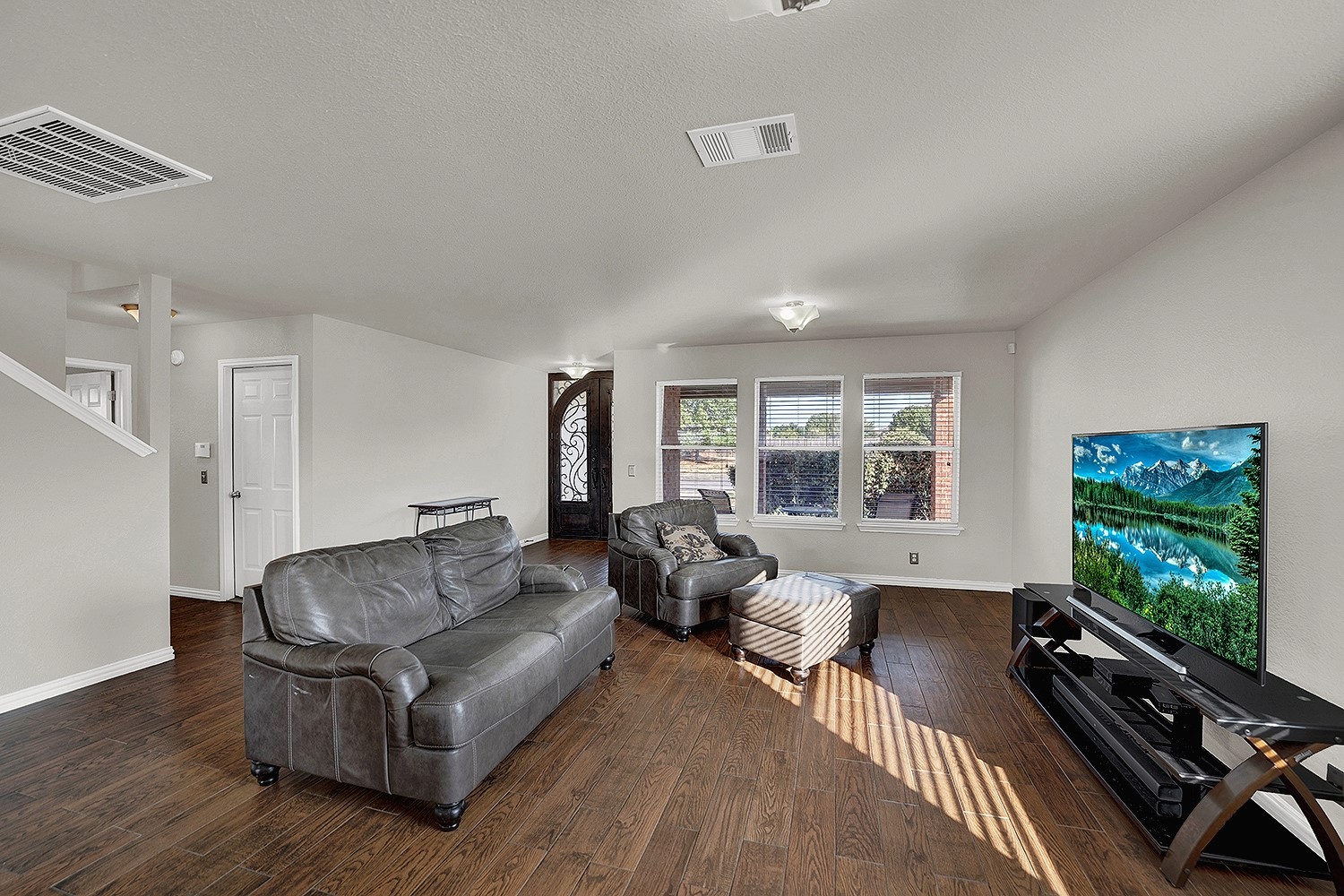 113 Endeavour Kyle, TX 78640 - Photo 7 of 38 Living room with view of garage door and stairs to upper level