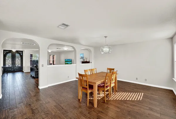 a large white kitchen with cabinets