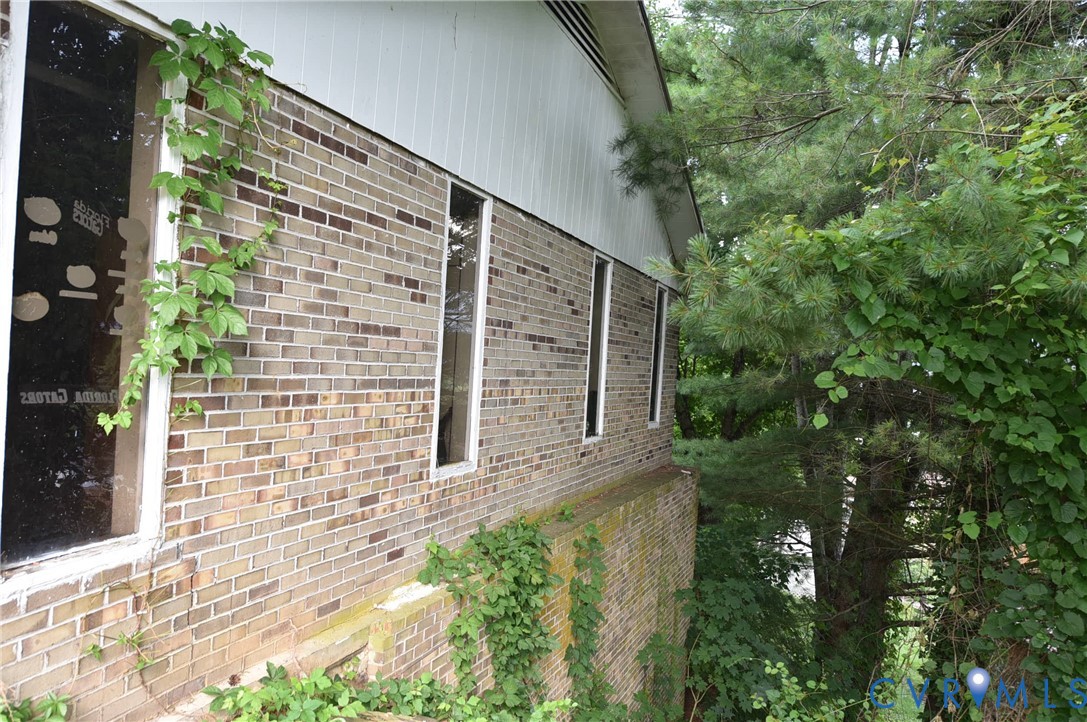642 Star Street Pounding Mill, VA 24637 - Photo 5 of 20 Brick exterior facade with multiple windows and wh