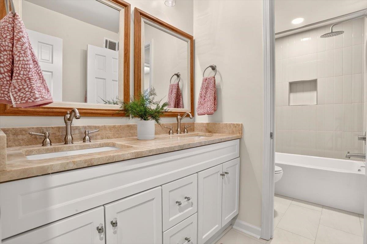 7674 Apple Valley Road Germantown, TN 38138 - Photo 11 of 15 Bathroom vanity with dual undermount sinks and a stone-finish countertop
