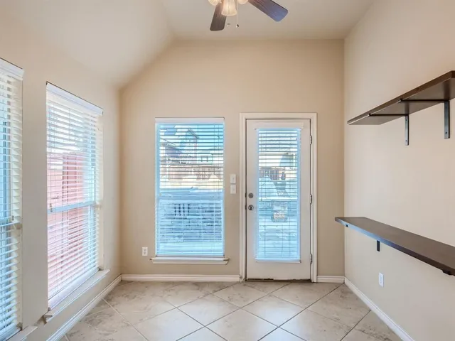 a view of a chairs and table in the backyard of the house