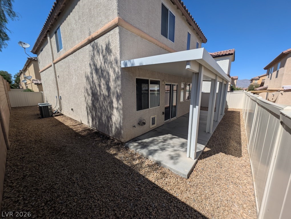 9121 Spoonbill Ridge Place Las Vegas, NV 89143 - Photo 24 of 26 A private patio, perfect for relaxing, is shaded by an elegant white pergola, offering tranquil outdoor living.