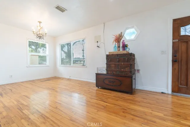 an empty room with windows and cabinet