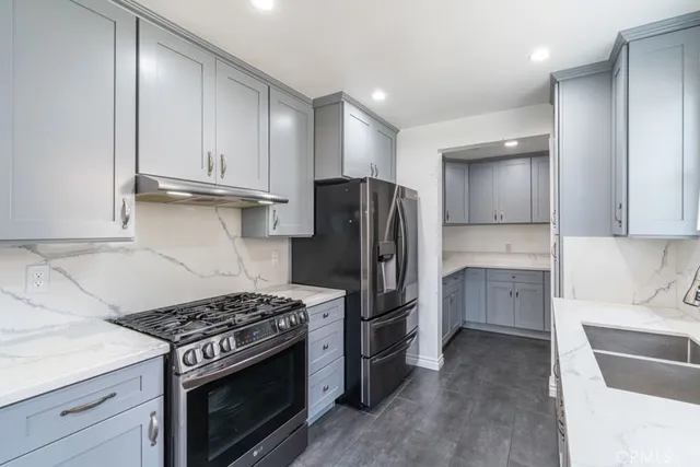 a kitchen with a stove and a refrigerator