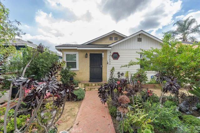 a view of a house with potted plants