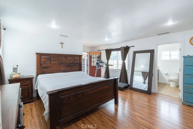 a room with a bed and wooden floor