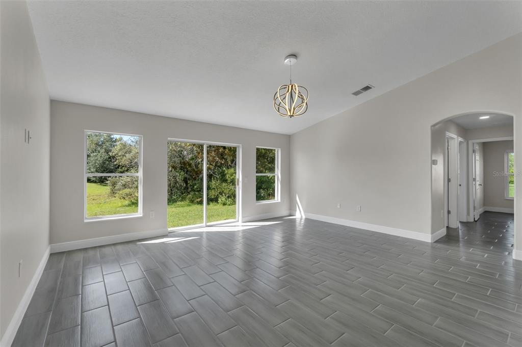506 Peace Way Kissimmee, FL 34759 - Photo 14 of 34 a view of an empty room with a window and wooden floor