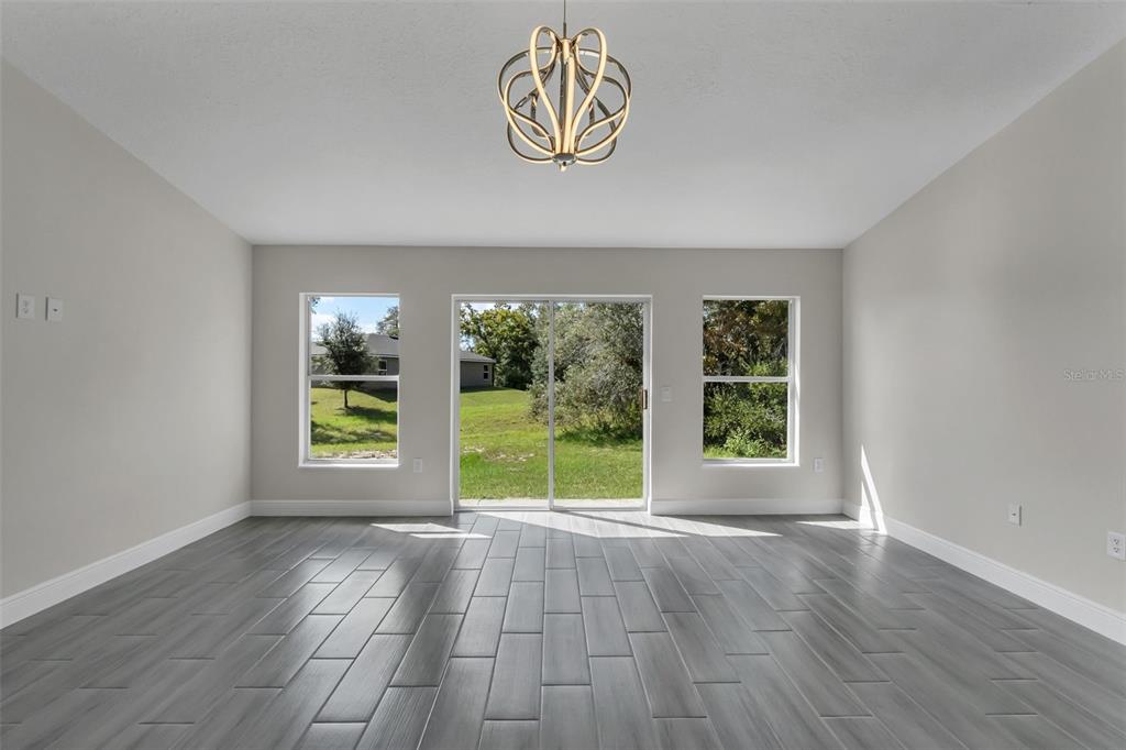 506 Peace Way Kissimmee, FL 34759 - Photo 15 of 34 an empty room with wooden floor and windows