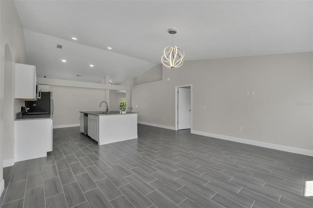506 Peace Way Kissimmee, FL 34759 - Photo 16 of 34 a view of kitchen with cabinets and wooden floor