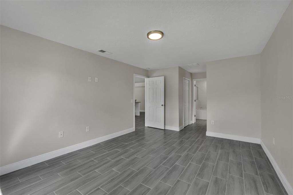 506 Peace Way Kissimmee, FL 34759 - Photo 20 of 34 a view of an empty room with wooden floor