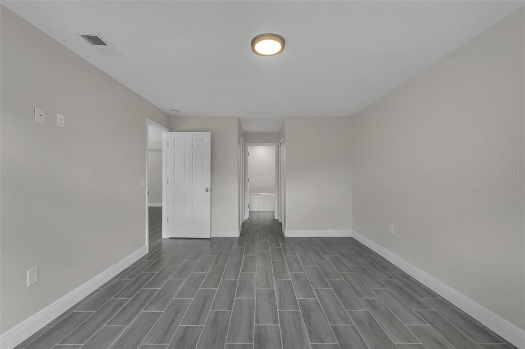 506 Peace Way Kissimmee, FL 34759 - Photo 21 of 34 a view of an empty room with wooden floor