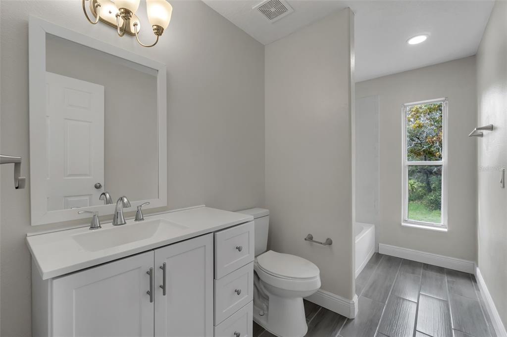 506 Peace Way Kissimmee, FL 34759 - Photo 25 of 34 a bathroom with a sink a toilet and a mirror
