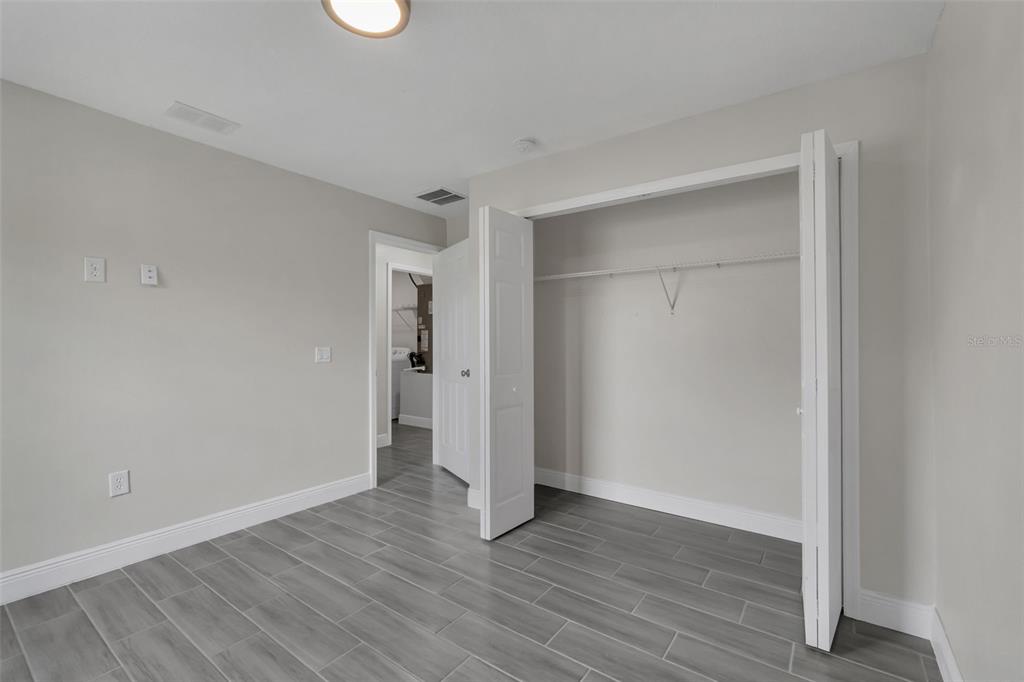 506 Peace Way Kissimmee, FL 34759 - Photo 28 of 34 a view of an empty room with wooden floor