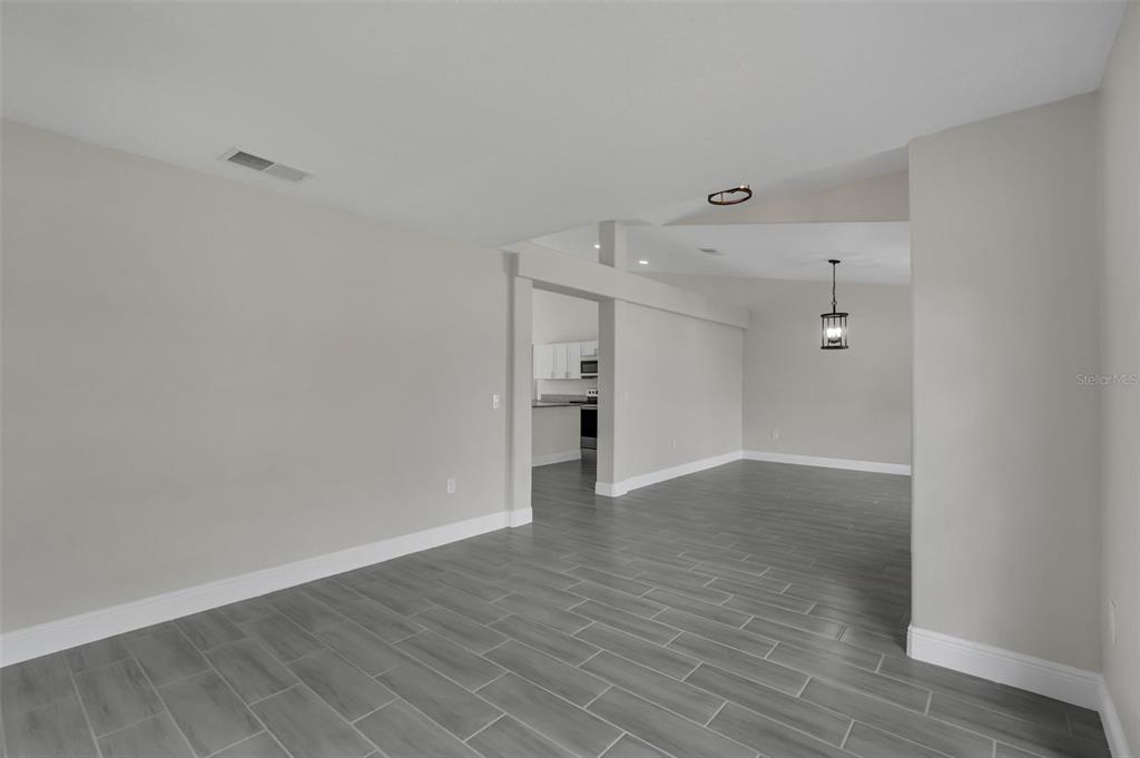 506 Peace Way Kissimmee, FL 34759 - Photo 7 of 34 a view of an empty room with wooden floor and a window