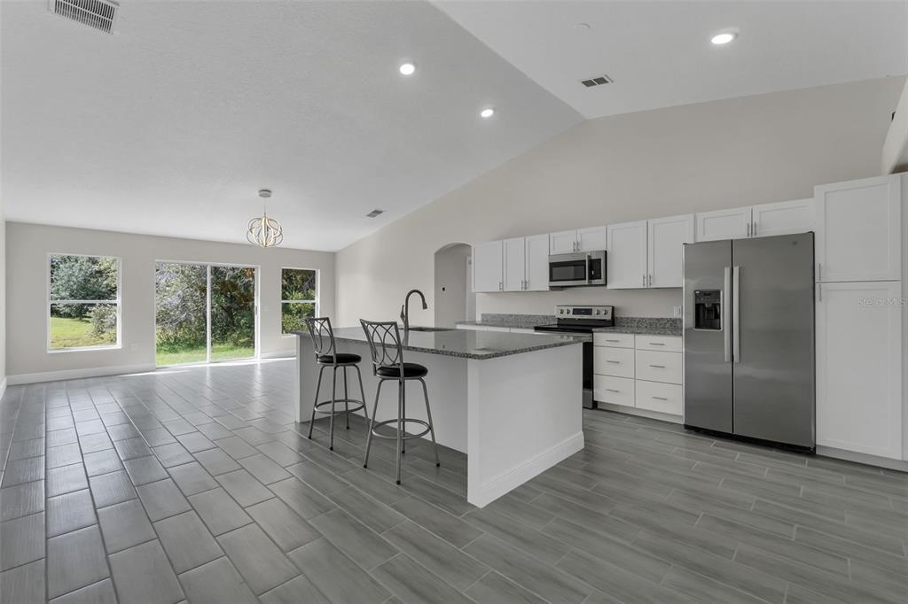 506 Peace Way Kissimmee, FL 34759 - Photo 8 of 34 a kitchen with cabinets and chairs