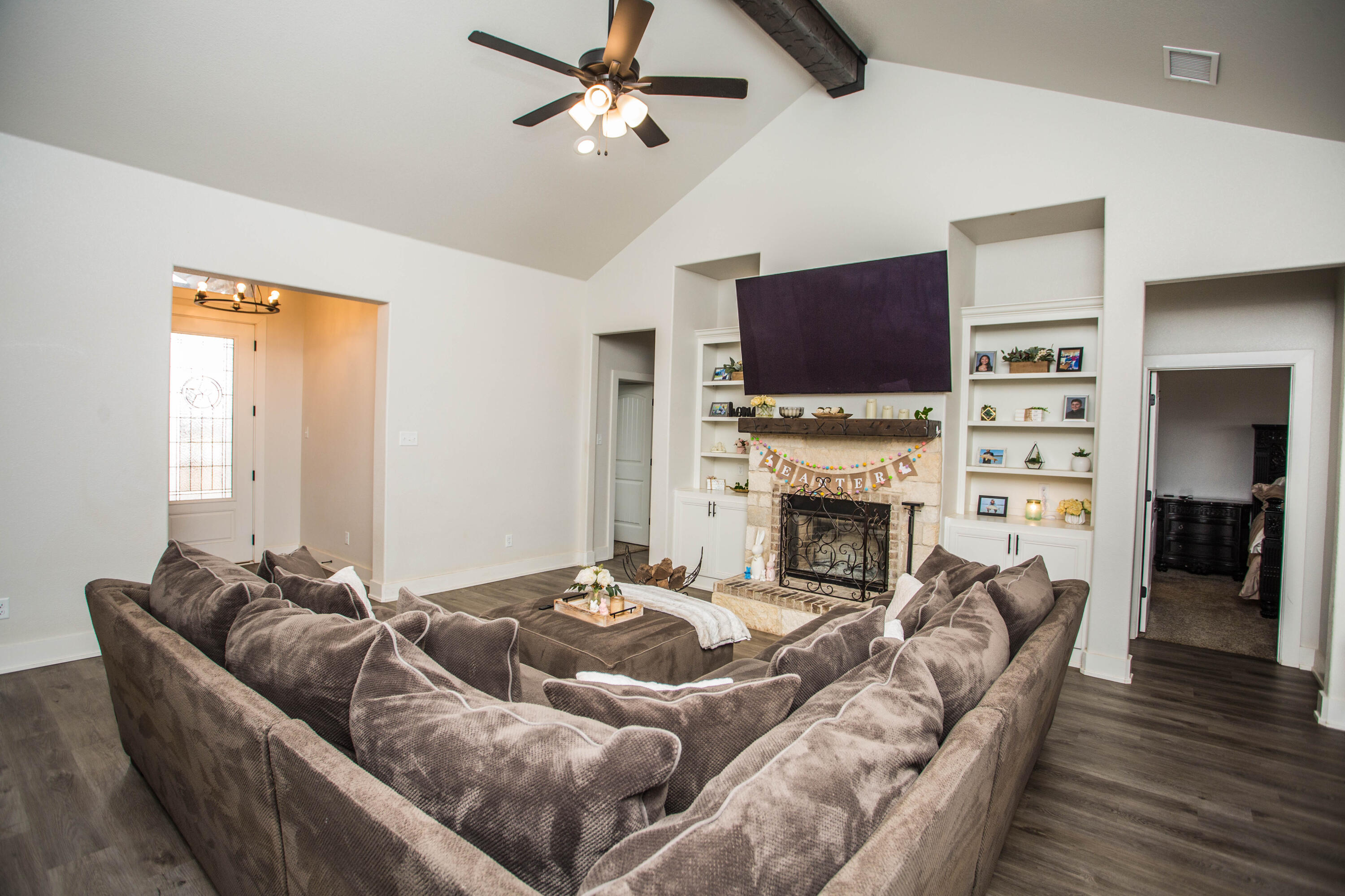 2204 County Road 7815 Lubbock, TX 79423 - Photo 12 of 58 a living room with furniture a flat screen tv and a fireplace