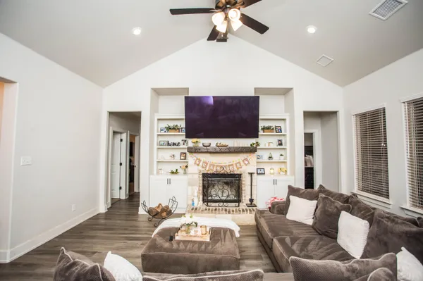 a living room with furniture and a fireplace