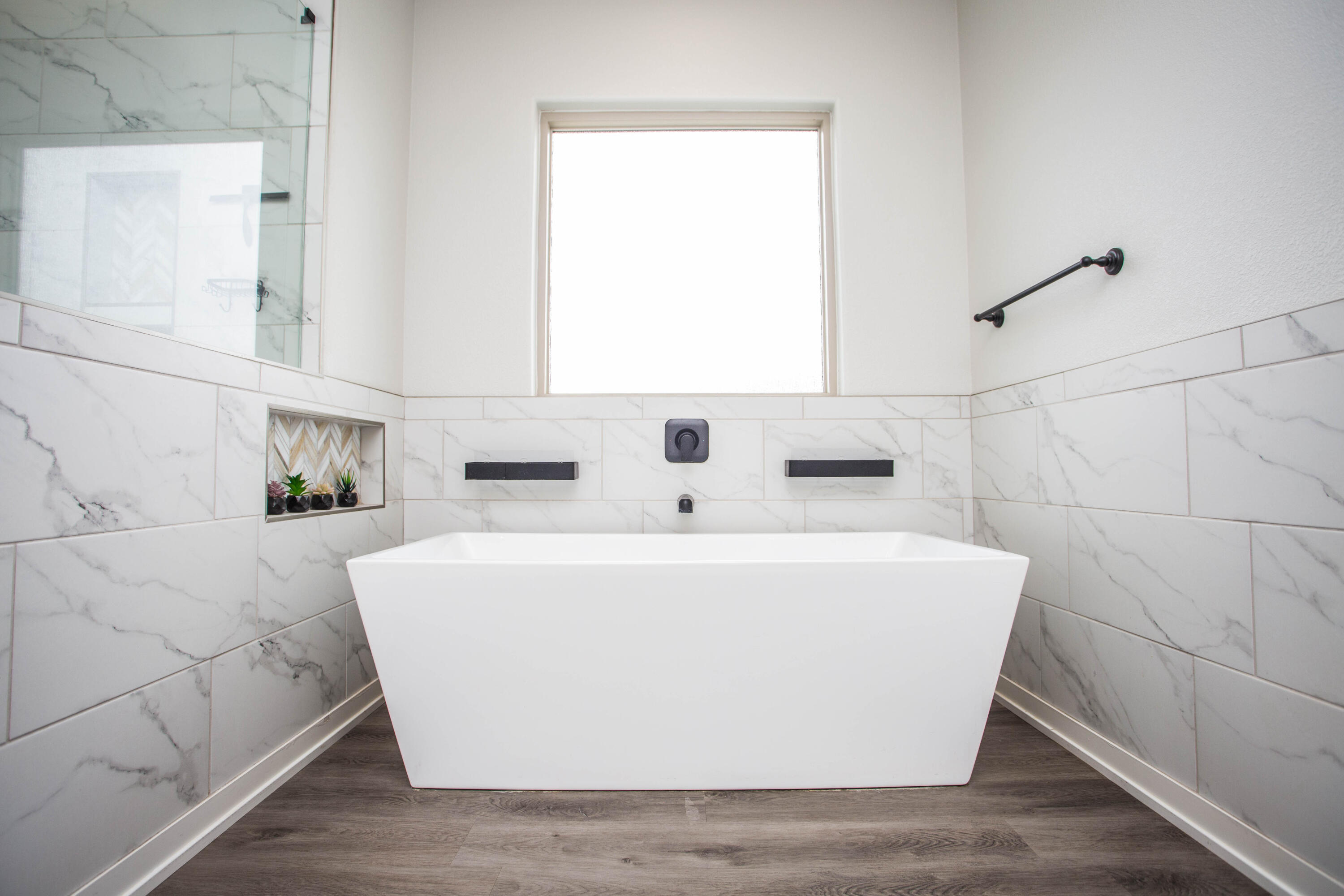 2204 County Road 7815 Lubbock, TX 79423 - Photo 34 of 58 a white bath tub sitting in a bathroom