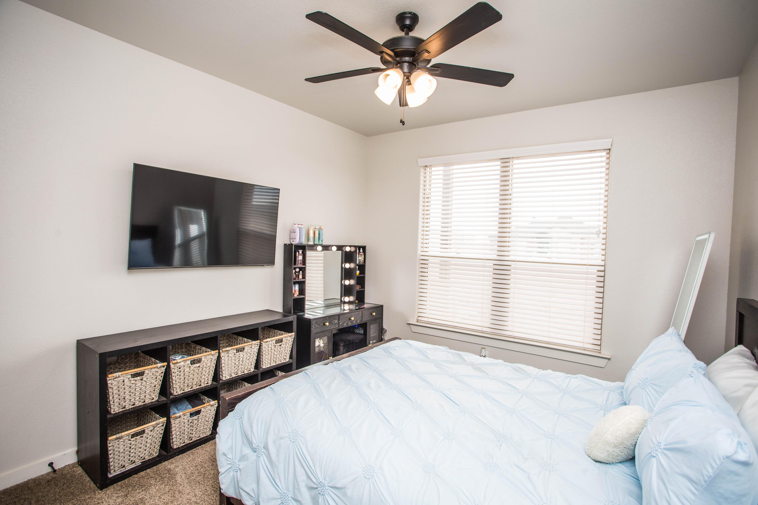 2204 County Road 7815 Lubbock, TX 79423 - Photo 44 of 58 a bedroom with a bed window and a flat screen tv