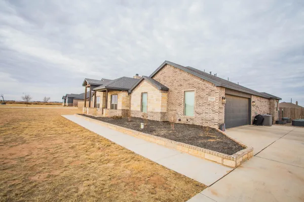 a front view of house with yard and ocean view