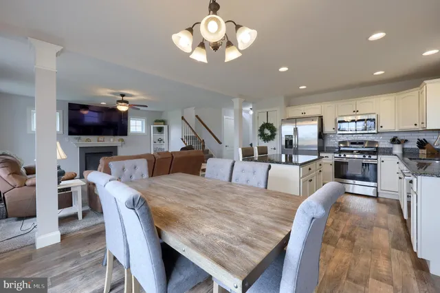 a large kitchen with a table and chairs