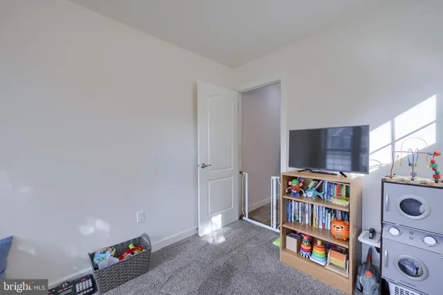 a living room with lots of books and a flat screen tv