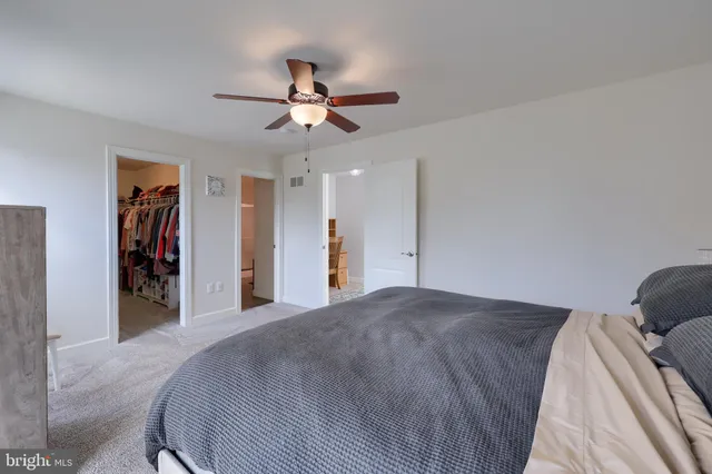 a view of a bedroom with a bed and closet