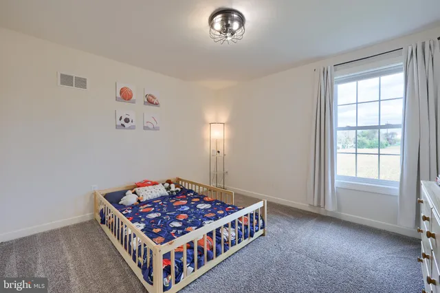 a room that has a bed and a dresser in it