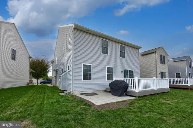 a view of a house with a yard and deck