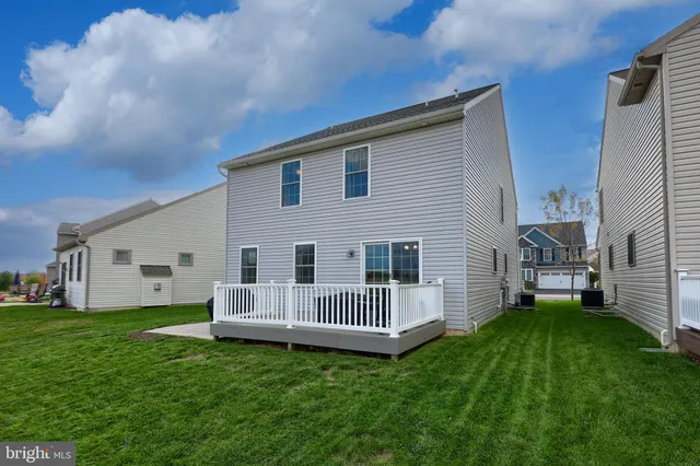 a view of a lake with houses in back