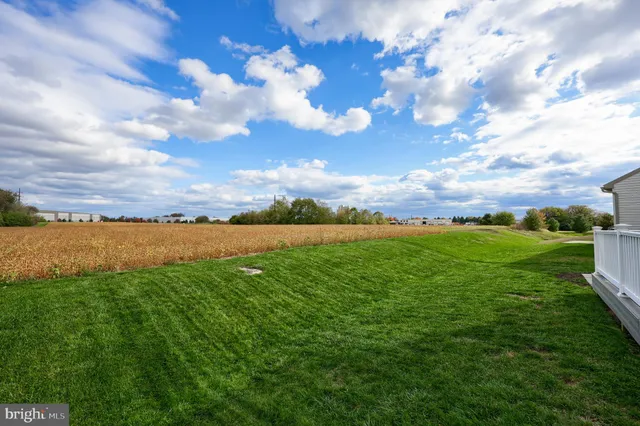 a view of a balcony with wooden floor and fence