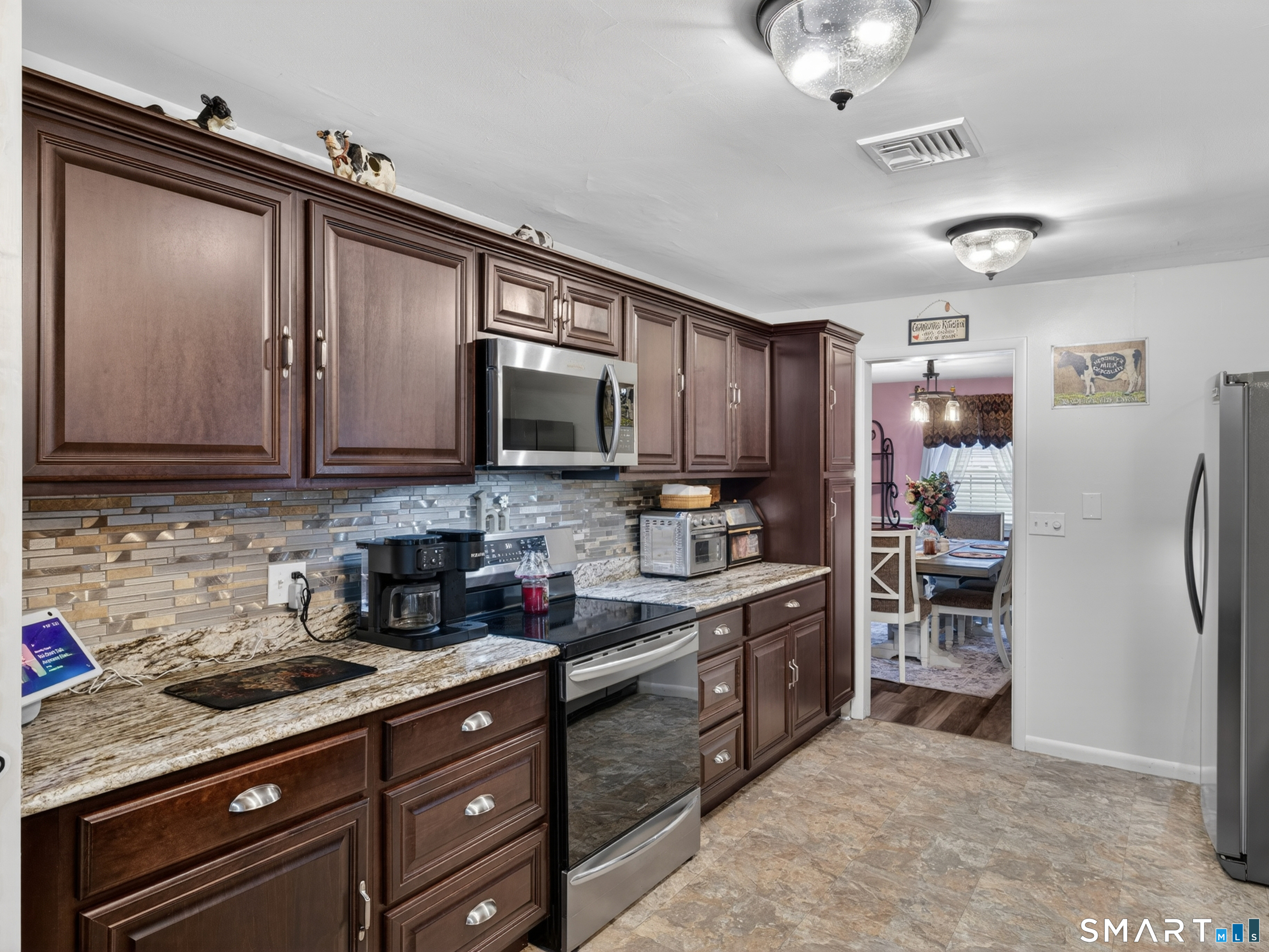 235 Scotland Road Norwich, CT 06360 - Photo 9 of 31 a kitchen with stainless steel appliances granite countertop a refrigerator and a stove top oven