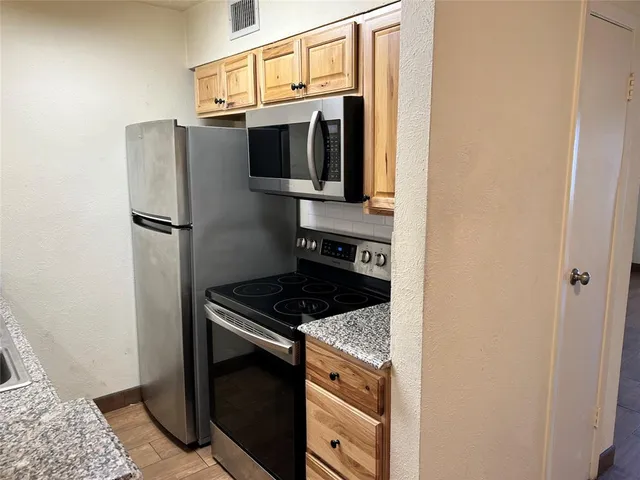 a view of a room with wooden floor