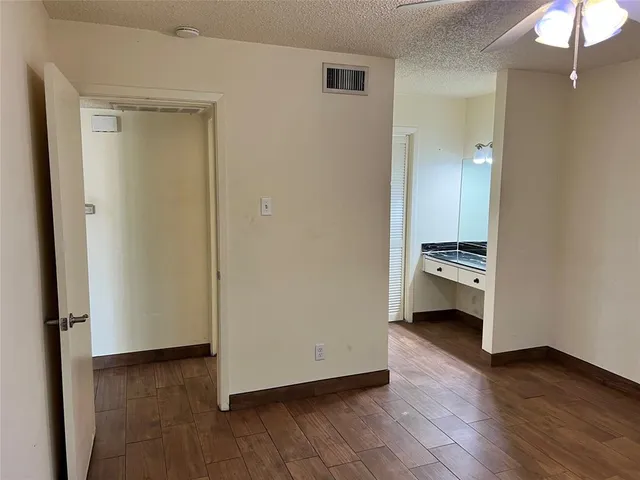 a bathroom with a sink a toilet a mirror and shower