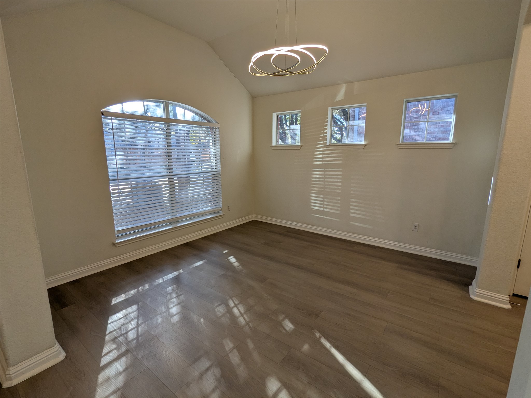 2008 Petrified Forest Drive Austin, TX 78747 - Photo 4 of 20 an empty room with wooden floor and windows