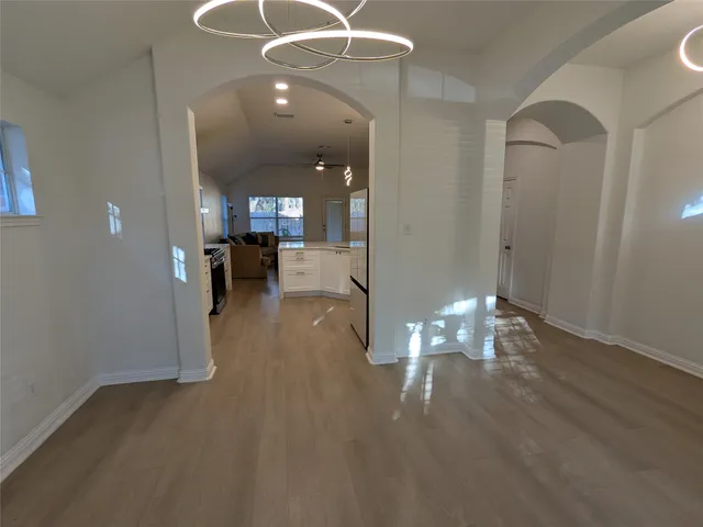 a kitchen with stainless steel appliances a refrigerator sink and white cabinets