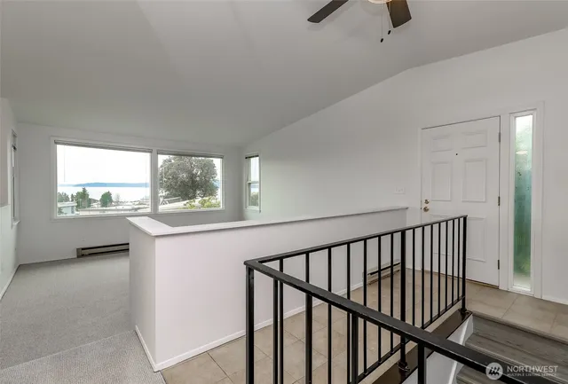 a view of hallway with furniture and a window