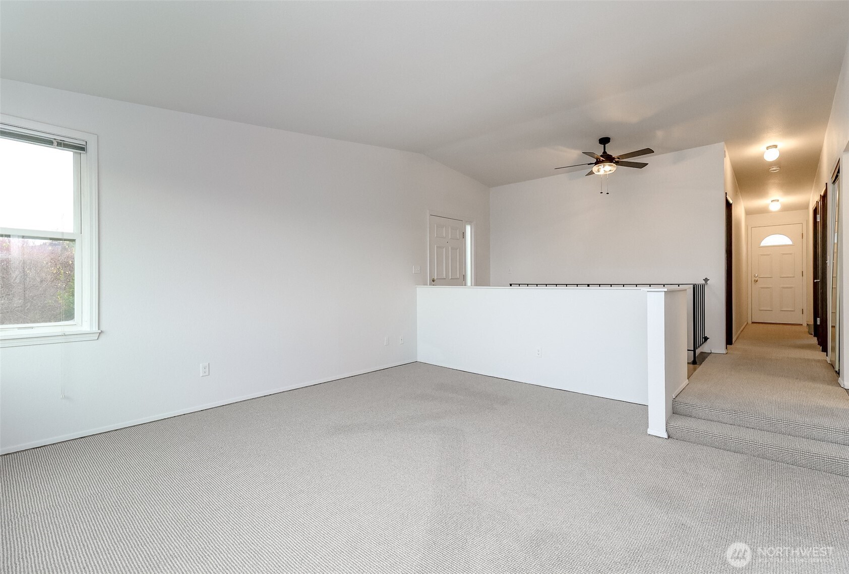 842 South 227th Place, Unit A Des Moines, WA 98198 - Photo 15 of 39 an empty room with a ceiling fan and carpet