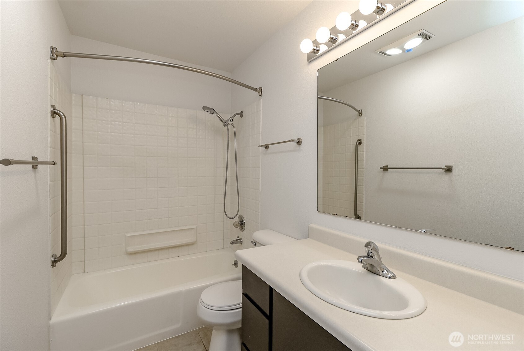 842 South 227th Place, Unit A Des Moines, WA 98198 - Photo 17 of 39 a bathroom with a toilet a sink a mirror a bathtub and shower